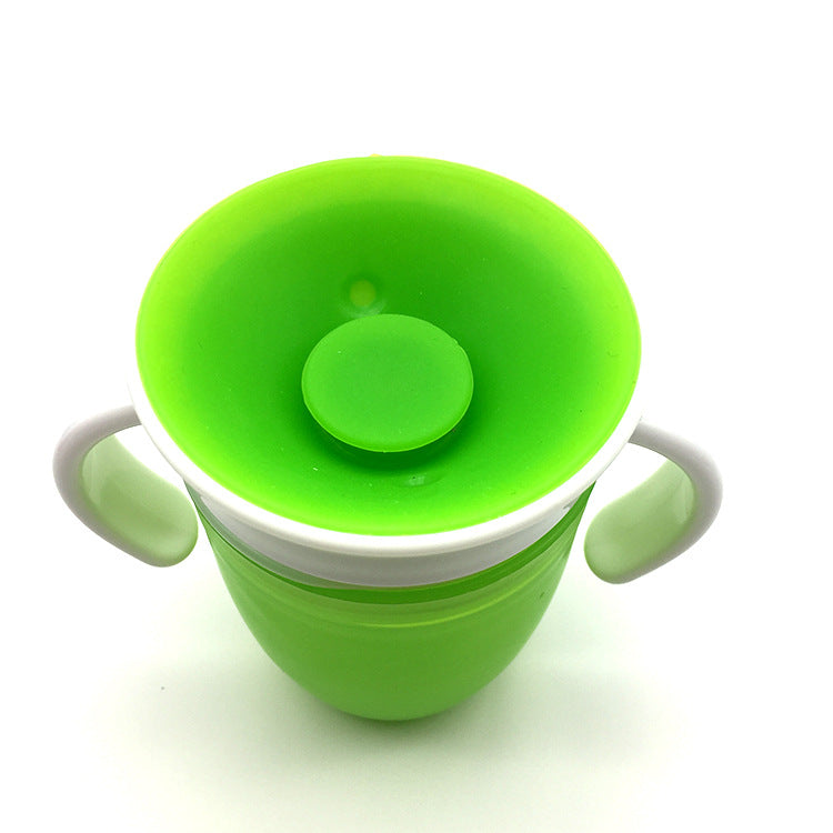 Green sippy cup with a white rim on a white background