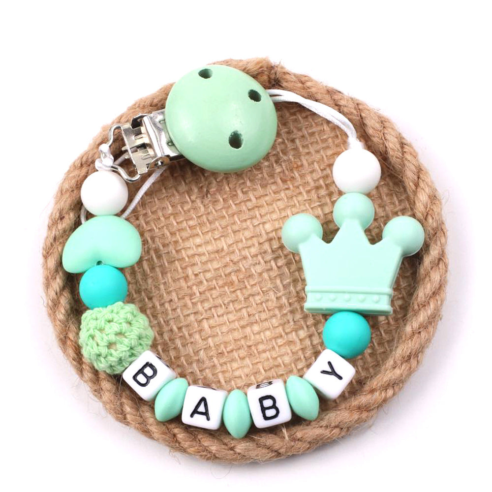 Baby Pacifier Chain with crown design and 'BABY' beads on a white background