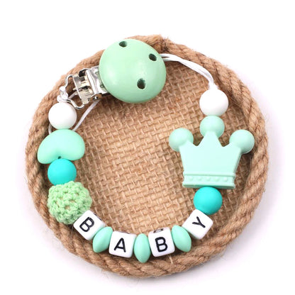 Baby Pacifier Chain with crown design and 'BABY' beads on a white background