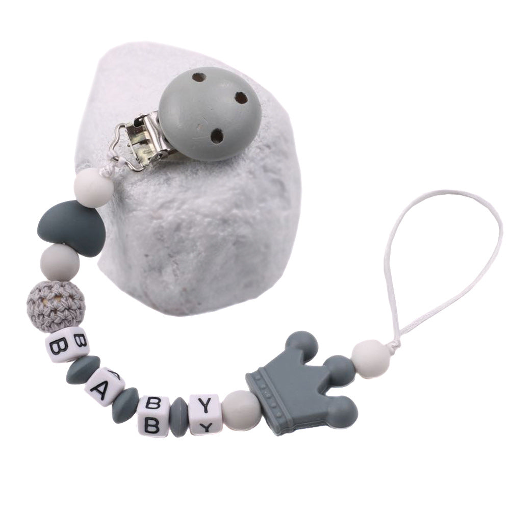 Baby pacifier chain with gray and white beads on a white background