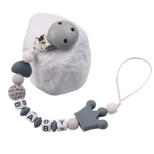 Baby pacifier chain with gray and white beads on a white background