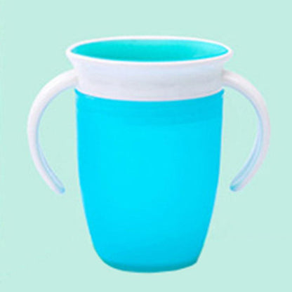 Blue 360 baby cup with white handles on a light green background